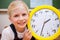 Schoolgirl showing a clock