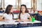 Schoolgirl Sitting With Classmate Looking At Her