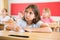 Schoolgirl sitting in classroom during lesson in elementary school