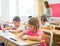 Schoolgirl sitting in classroom during lesson in elementary school