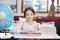 Schoolgirl Sitting At Desk