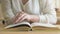 Schoolgirl sitting at the desk flips pages of book