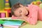 Schoolgirl sleeping after doing homework