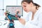 schoolgirl student adjusts industrial robot arm model stock photo