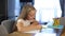 Schoolgirl studies online using a modern laptop. Homework