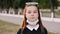 Schoolgirl takes off a medical mask from her face