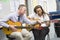 Schoolgirl and teacher playing guitar