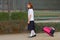 Schoolgirl with trolley bag