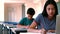 Schoolgirl using laptop while studying in classroom