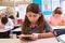 Schoolgirl using tablet computer in elementary school class