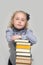 Schoolgirl with a very high stack of books