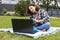 A schoolgirl watches an Internet class and studies remotely. The girl uses wireless internet technologies. A pretty young teenage