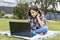 A schoolgirl watches an Internet class and studies remotely. The girl uses wireless internet technologies. A pretty young teenage