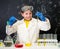 Schoolgirl in white gown doing experiments with liquids