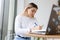 Schoolgirl writes homework while sitting at a table in a cafe