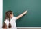 Schoolgirl writing chalk on a blackboard, empty space, education concept