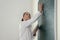 Schoolgirl writing chemistry formula on blackboard