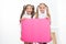 Schoolgirls hold advertisement poster copy space. Children hold advertising banner. Happy pupils children with blank