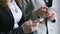 Schoolgirls hold smart phones in hands indoors