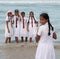 Schoolgirls in uniform playing on the beach