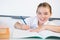 Schoolkid doing homework in classroom