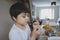 Schoolkid eating toasted and fresh orange juice for his breakfast before go to school, Portrait Healthy child boy eating butter on
