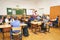 Schoolkids in the classroom sitting at their desks