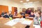 Schoolkids in the classroom sitting at their desks and listen to the teacher