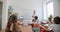 schoolkids sitting at desks in classroom and listen to the teacher. Back shot