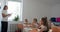 schoolkids sitting at desks in classroom and listen to the teacher. Vercion 4
