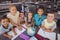 Schoolkids studying globe in library