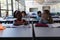 Schoolkids studying on windmill model at desk in classroom