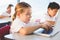 Schoolkids using laptop in classroom