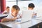 Schoolkids using laptop in classroom