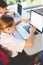 Schoolkids using laptop in classroom