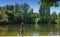 Schwabinger See , girl strolling along a small lake in Munich