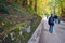 SCHWANGAU, GERMANY - OKTOBER 09, 2018: Tourists walk in the autumn forest on the road in park