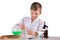 Science boy pours green liquid from flask into glass