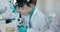 Science, classroom and students in laboratory with microscope for learning, lesson and education. Chemistry, school and