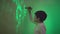 science and development, a smart male child with a flashlight in his hands draws patterns on the wall illuminated with