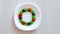 Science experiment for kids. Circle of colored candies on white plate