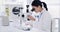 Science, innovation and research with a woman scientist looking through a microscope for medical analysis in a