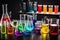 science lab with beakers, flasks, and test tubes filled with colorful liquids