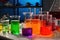 science lab with beakers, flasks, and test tubes filled with colorful liquids