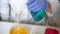 Science laboratory. Chemist in blue gloves, white uniform mixing yellow and blue liquids in glass flask. Chemical