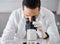 Science, microscope and a doctor man at work in a laboratory for innovation or research. Medical, analytics and