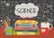 SCIENCE in speech bubbles above science books, pens box, apple and mug with science doodles on chalkboard background