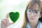 Science whit green spirit mind. Green heart in her hand on lab a background. Beautiful smiling female doctor or Scientist.