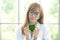 Science whit green spirit mind. Green heart in her hand on lab a background. Beautiful smiling female doctor or Scientist holding