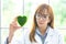 Science whit green spirit mind. Green heart in her hand on lab a background. Beautiful smiling woman doctor or Scientist holding